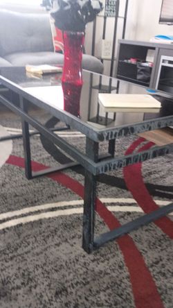 Metal frame coffee table with black glass top