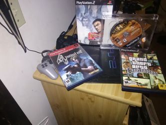 Ps2 with 2 controllers, cords and 4 games