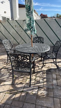 Iron circular patio table and 4 chairs