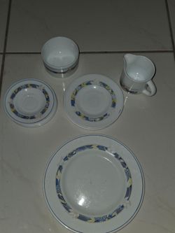 Matching ceramic dinnerware set with blue floral rim. Includes saucers, creamer, sugar bowl and dinner plate. No chips or cracks. Local pickup only. $