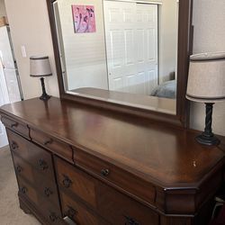 Large long dresser with attached mirror and two nightstands