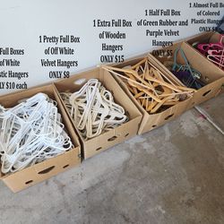 7 Boxes of Hangers – Plastic, Wood. Rubber and Velvet