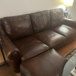 Brown leather couch and ottoman