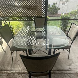 Glass dining table with four chairs