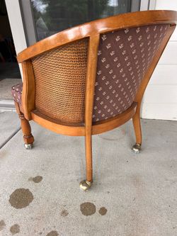 Four cane back chairs with rollers.