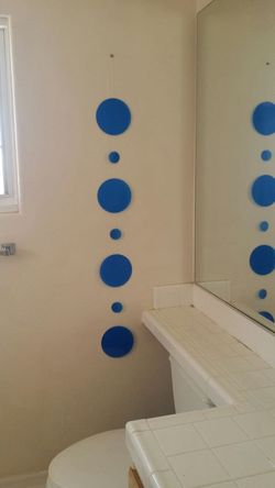 Wall or ceiling hanging ornament. Blue circles will turn in the breeze.