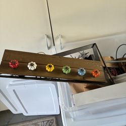 Hanging plaque with porcelain knobs.