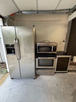 Stainless Steel Frigidaire Refrigerator/Freezer, Electric Range, Matching Microwave Vent, Wine Cooler