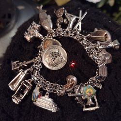 Vintage sterling silver menards charm bracelet with 19 charms and double links