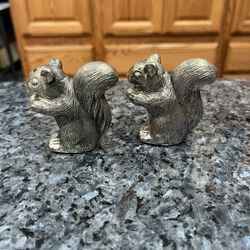 Vintage Cast Metal Squirrels silver tone pair of Salt and Pepper Shakers.  Made in Japan stickers on the side of the squirrels.  Size approximately 2 