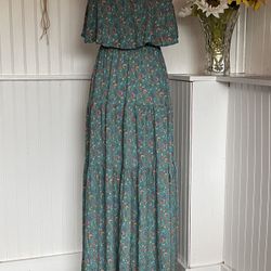 Turquoise print maxi dress with pink and yellow flowers.