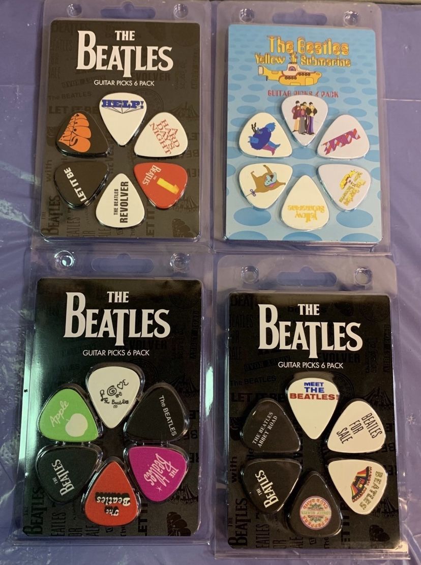 Brand new - 4 collectible Beatles guitar pick packs - great gift for a Beatles fan