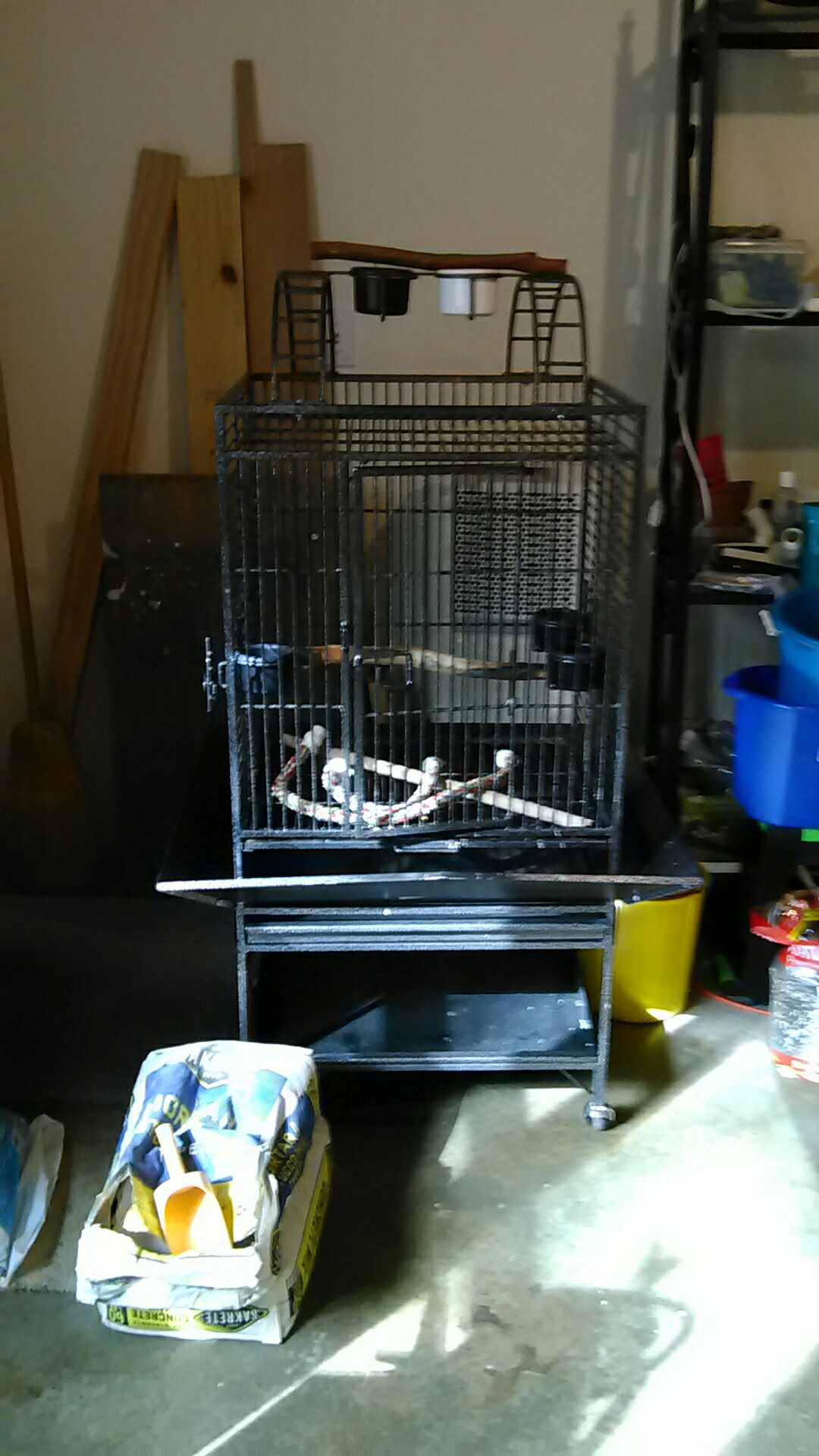 California powder coated bird cage, cage only 24by20 by 27. 1" bar spacing. play top. Height with stand 56", seed guards. $125.