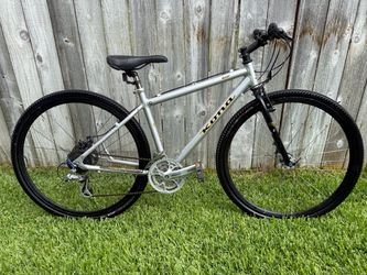 silver aluminum Kona Dew hybrid/commuter bicycle