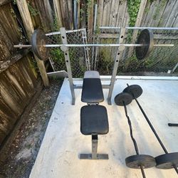 Bench With  A Bar And 2x25 Lbs And 2x10 Plates 