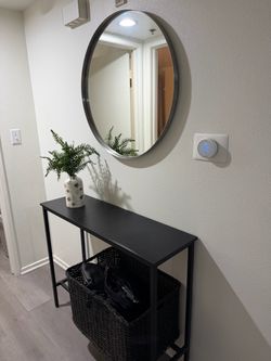 Round Wall Mirror with Black Metal Frame and console table