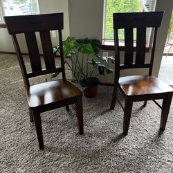 Two solid wood dining chairs