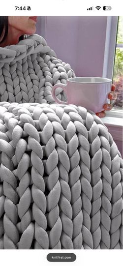 Beautiful oversized KnitFirst chunky-knit weighted blanket in gray.