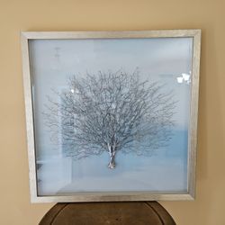 Picture Of  a Beautiful Tree In Silver And Delicate Color Blue Background 