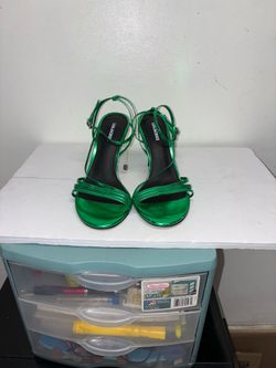 of metallic green strappy stiletto sandals by the Spanish footwear brand Lola Cruz.