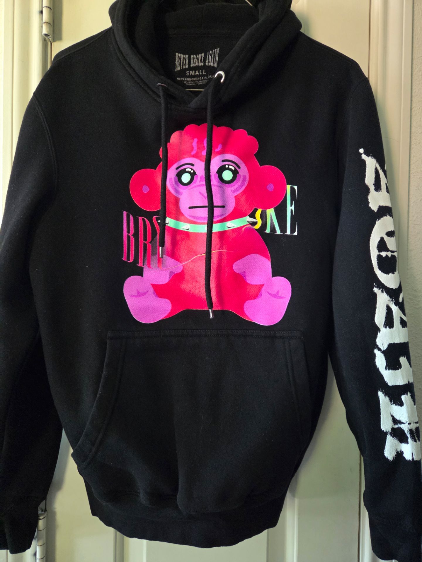 Never Broke Again Adult size S hoodie featuring a pink cartoon monkey graphic.
Like new condition!