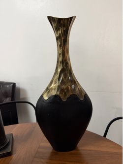 modern teardrop-shaped decorative vase featuring a striking two-tone black and gold design