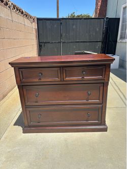 Brown two drawer dresser with flip down slot