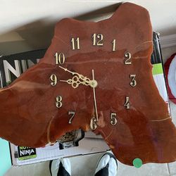 Hand cut Wooden clock. It is finished with light lacquer to preserve and enhance the wood coloring. 