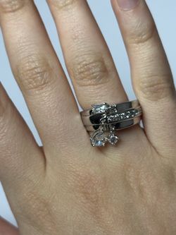 Silver and rhodium rings; accents of cubic zirconia and crystal. Beautiful design. Excellent quality.