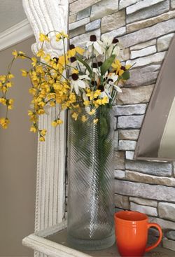 Beautiful glass vase with silk flowers .