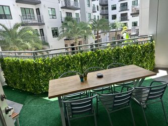 Privacy screen, turf, and patio furniture