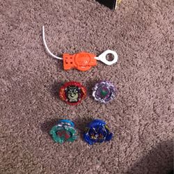 Four beyblades with launcher