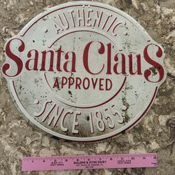 Vintage-style sign with 'Authentic Santa Claus Approved Since 1855' text. Made to look weathered.