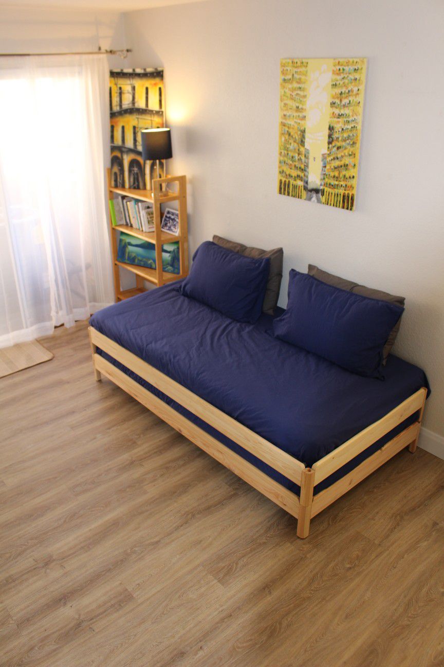 Stackable IKEA "Utaker" twin bed frames with twin mattresses