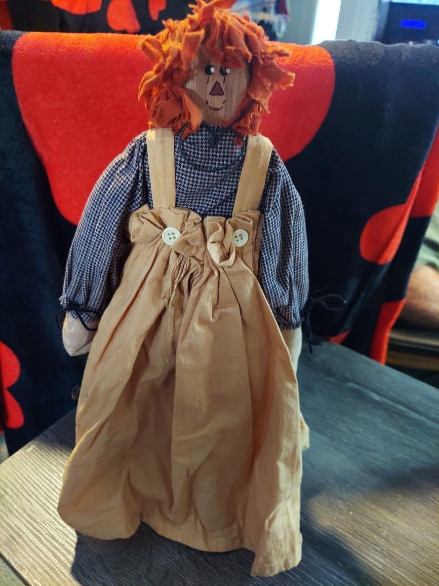 A wooden raggedy Ann