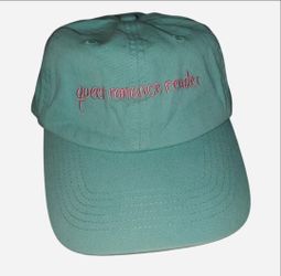 "queer romance reader" blue green hat with pink embroidered writing & adjustable strap