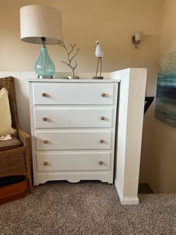 White dresser with four drawers.