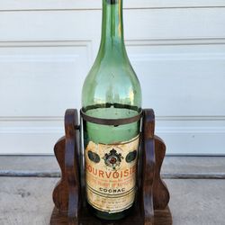 Empty Courvoisier Cognac Vintage Large Green Bottle on Wood Stand