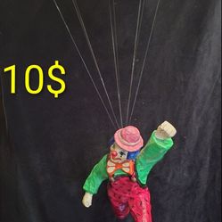 Vintage handmade paper mache clown dangling from a parachute,