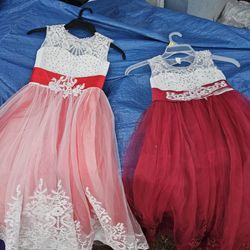 2 beautiful girls dresses. Great for Easter or a wedding. The on says size 6-7 the other has no tag.
