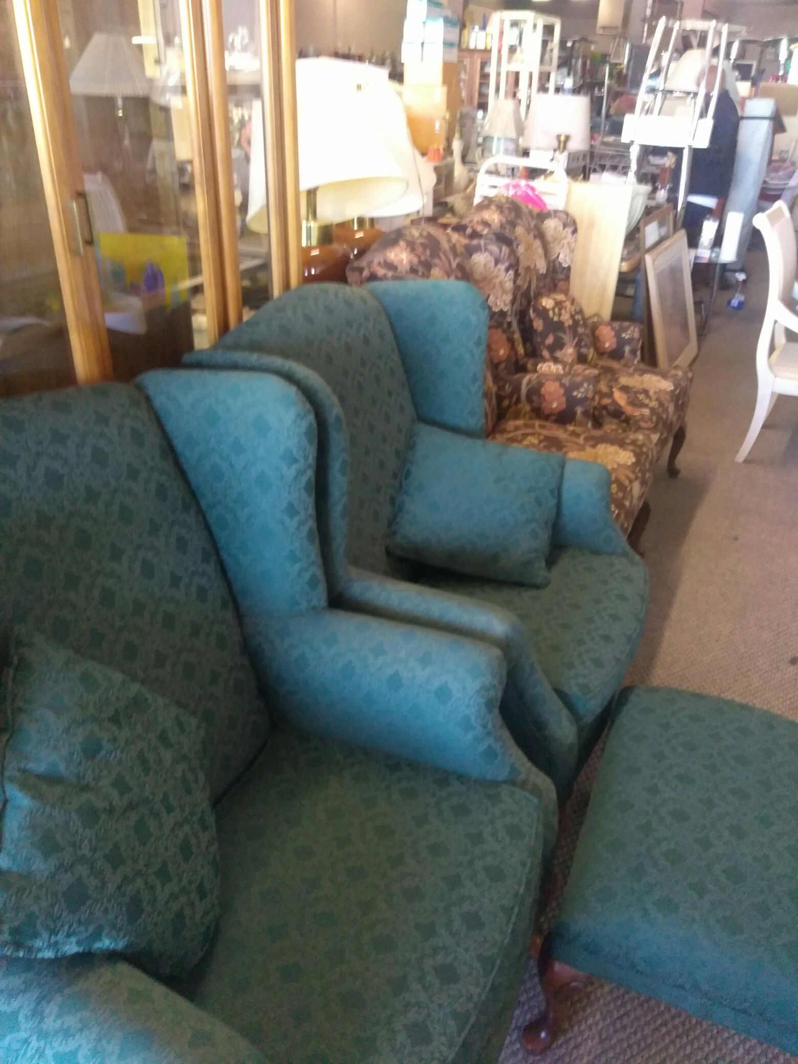 Wingback chairs with ottoman.