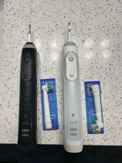 Two oral B electronic toothbrushes