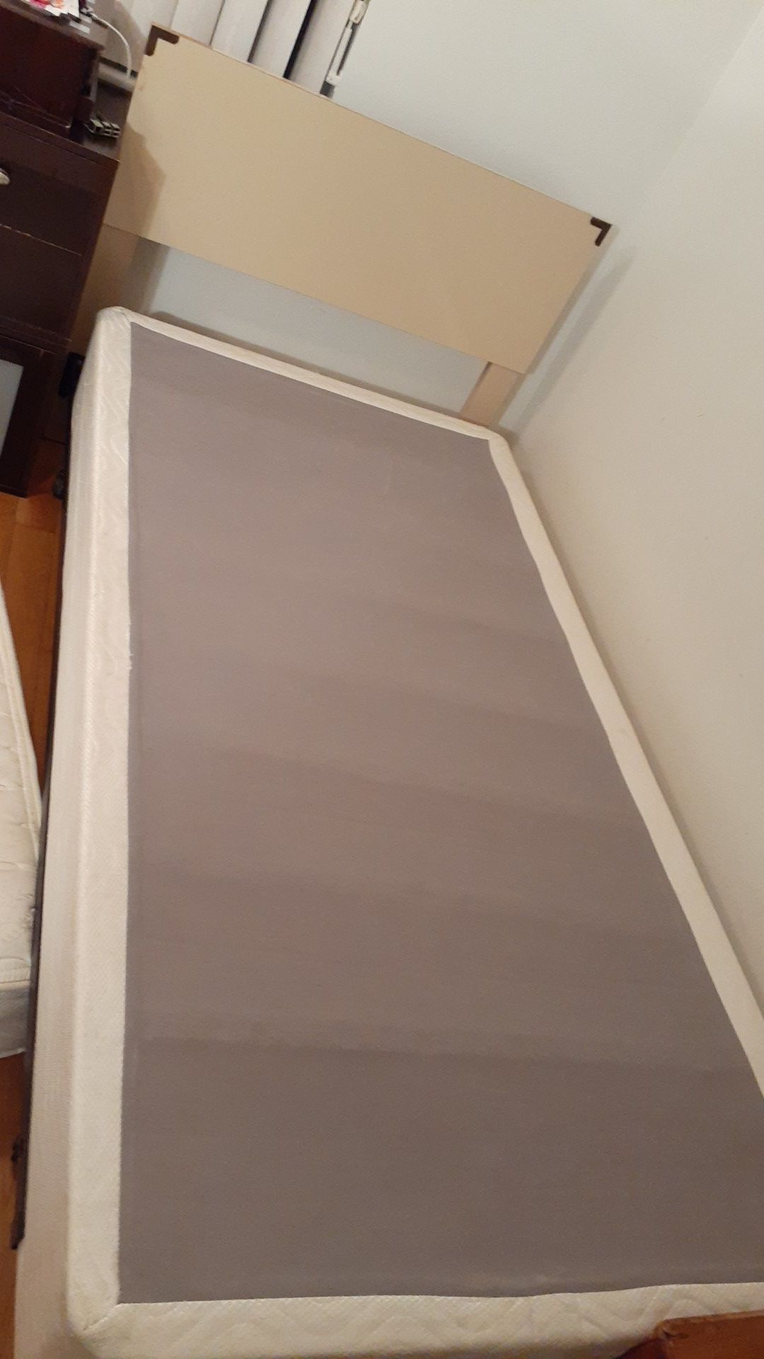 Bed with mattress and metal wheels