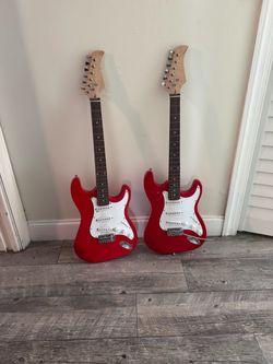 Pair of red and white electrical guitars Pair of red and white electrical guitars