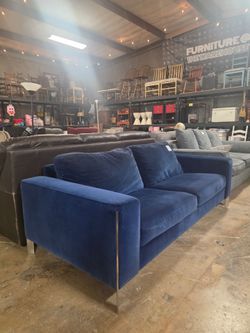 Pre-owned navy velvet sofa featuring chrome legs, $300