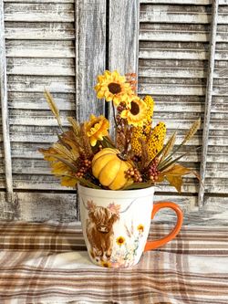 Ht-10.5in width-11in HANDMADE artificial Fall arrangement in a Highland cow coffee cup