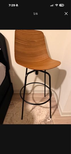 Blu Dot Clean Cut Swivel Stool in walnut wood veneer with a black powder-coated steel base.