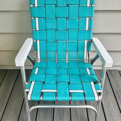 Vintage Aluminum folding webbed lawn chair. White plastic arm rests.  17” ground to the seat (off the ground ) back is ground to top 35”, and width 23