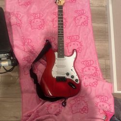 Red Electric Guitar With Black straps and Amp