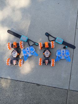 Two remote controlled cars with regular & wrist controls.